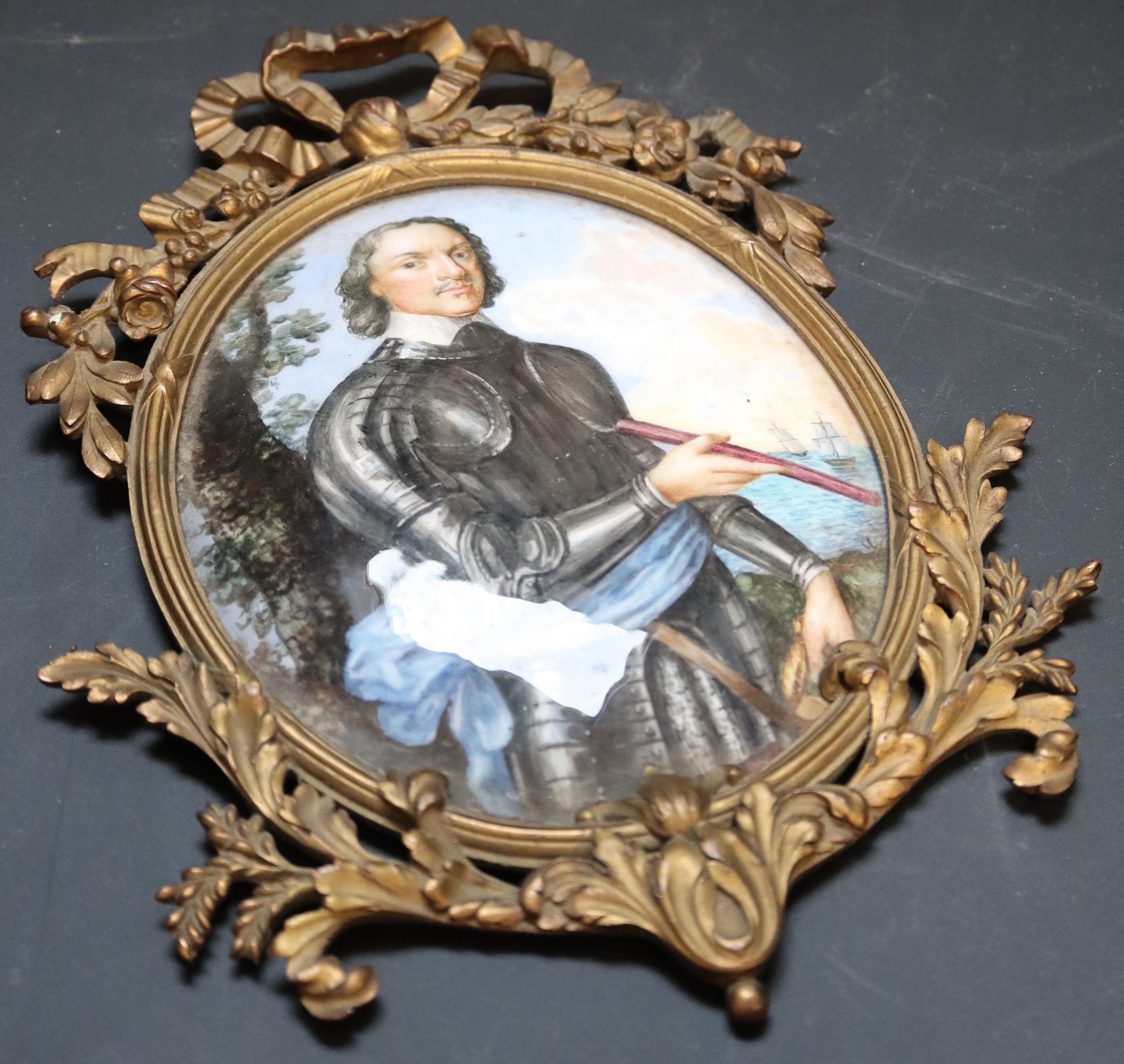 A 19th century French ormolu framed enamel plaque, depicting a 17th century explorer